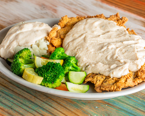 Country Fried Steak with mashed potato and steamed vegetables